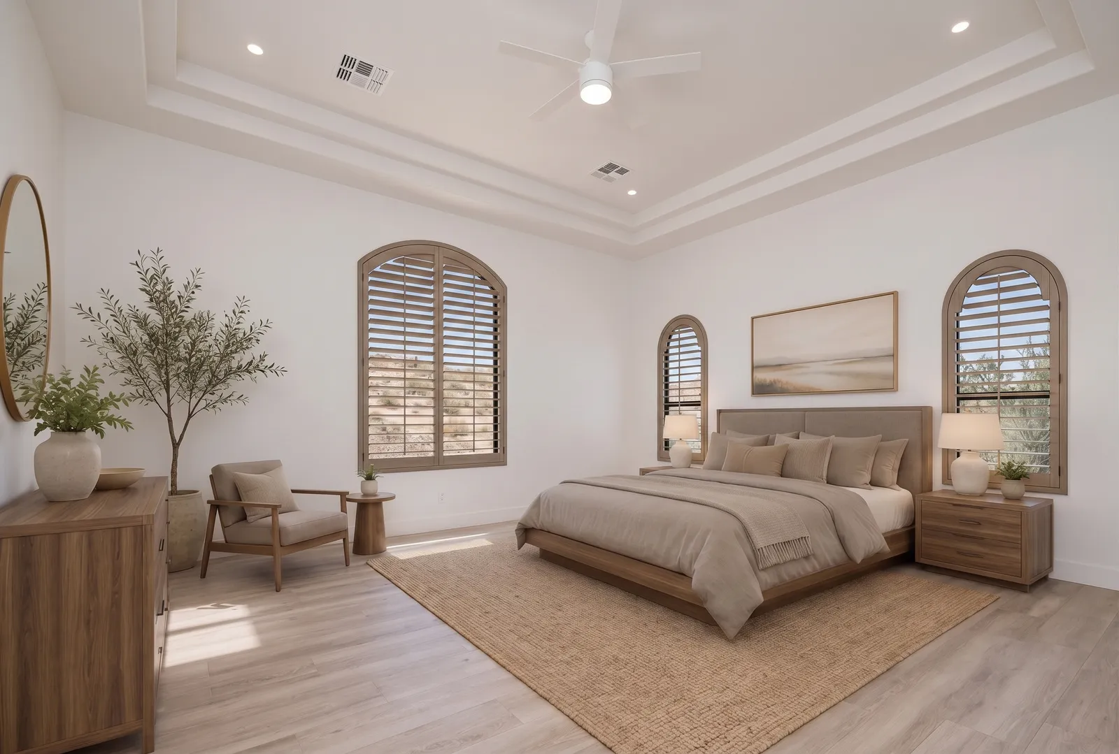 Louvered arched wood plantation shutters in a Scottsdale, Arizona primary bedroom