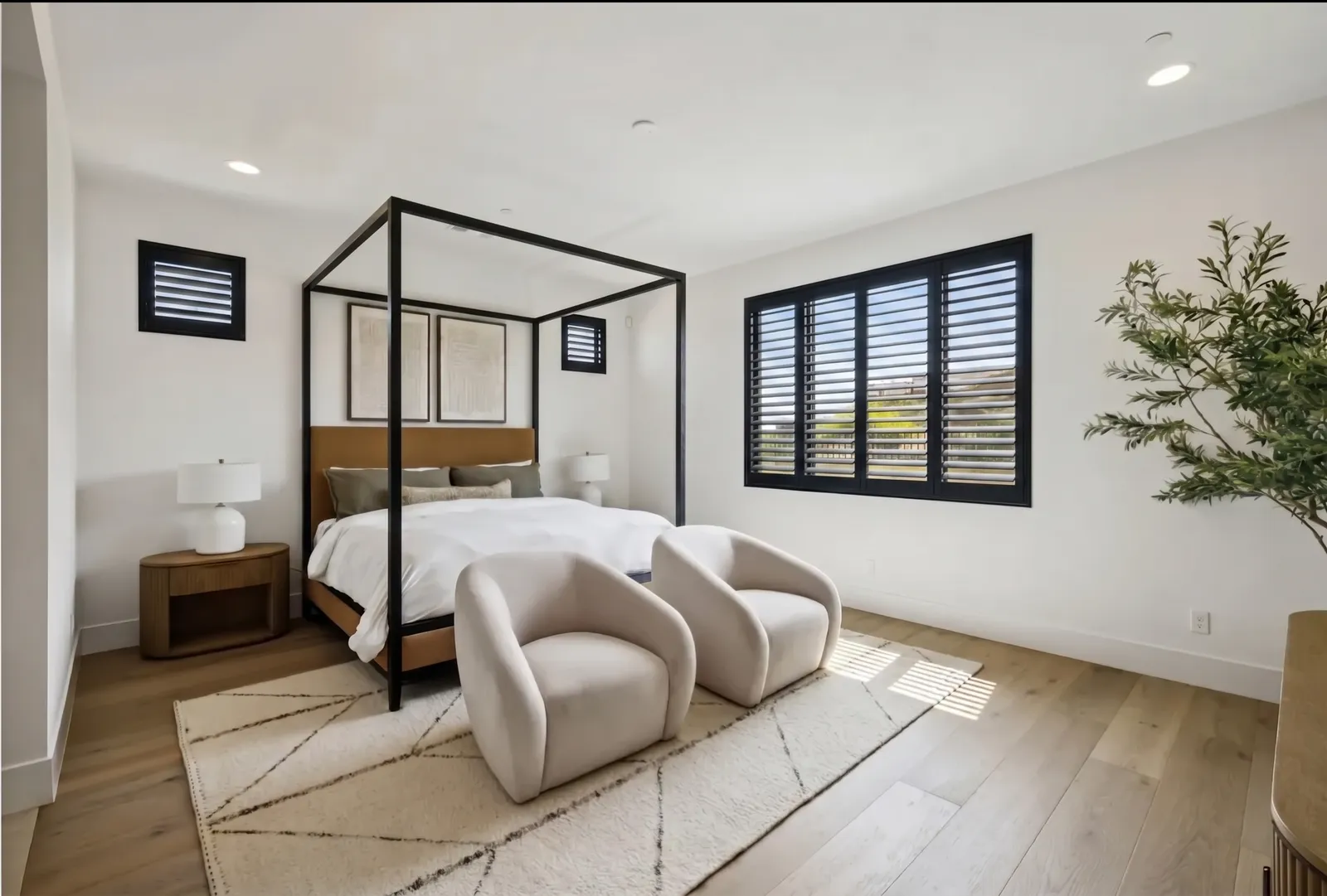 Black-stained wood plantation shutters in a Mesa, Arizona primary bedroom