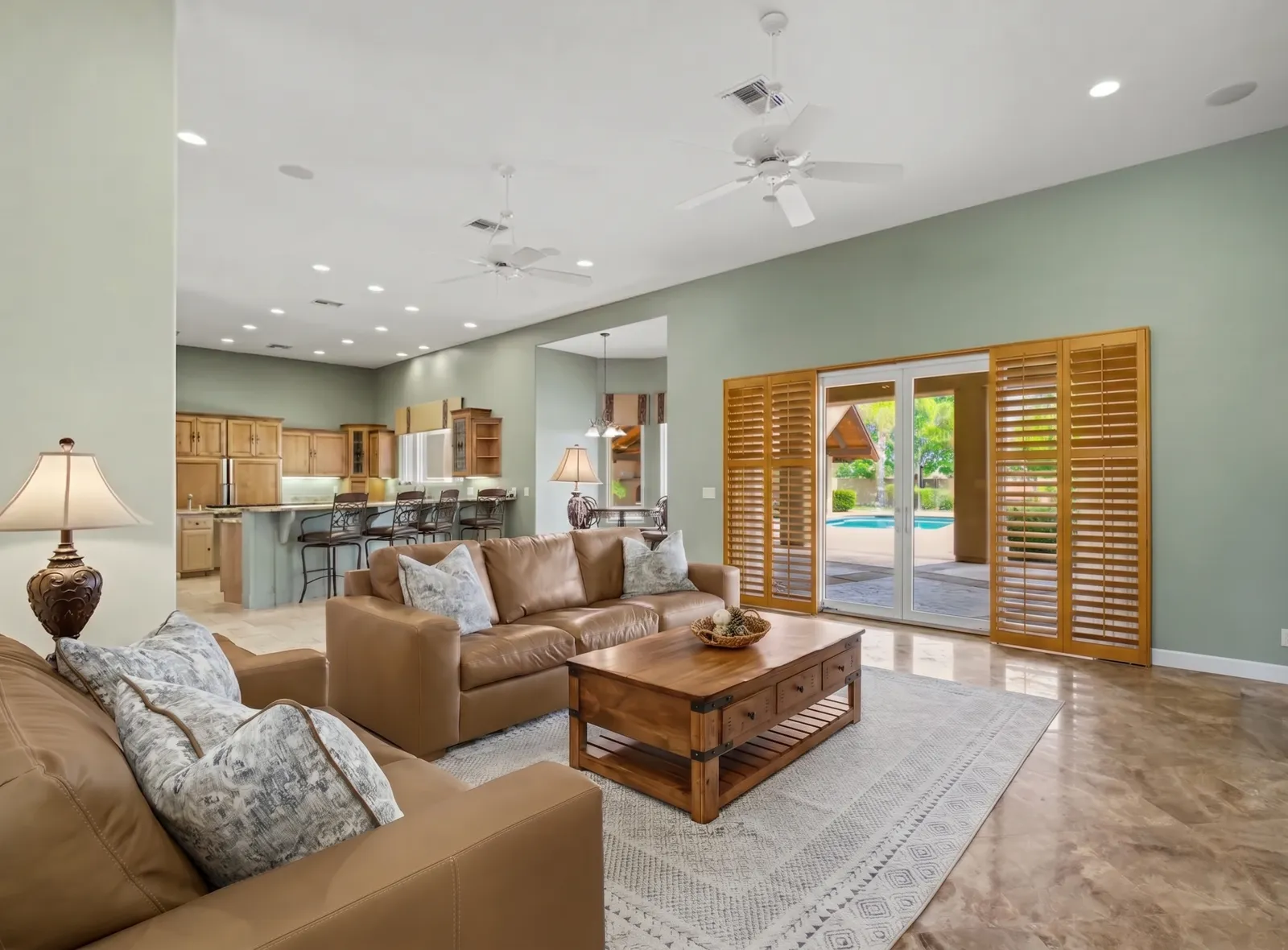 Oak wood plantation shutters on a sliding glass door in a Surprise, Arizona home