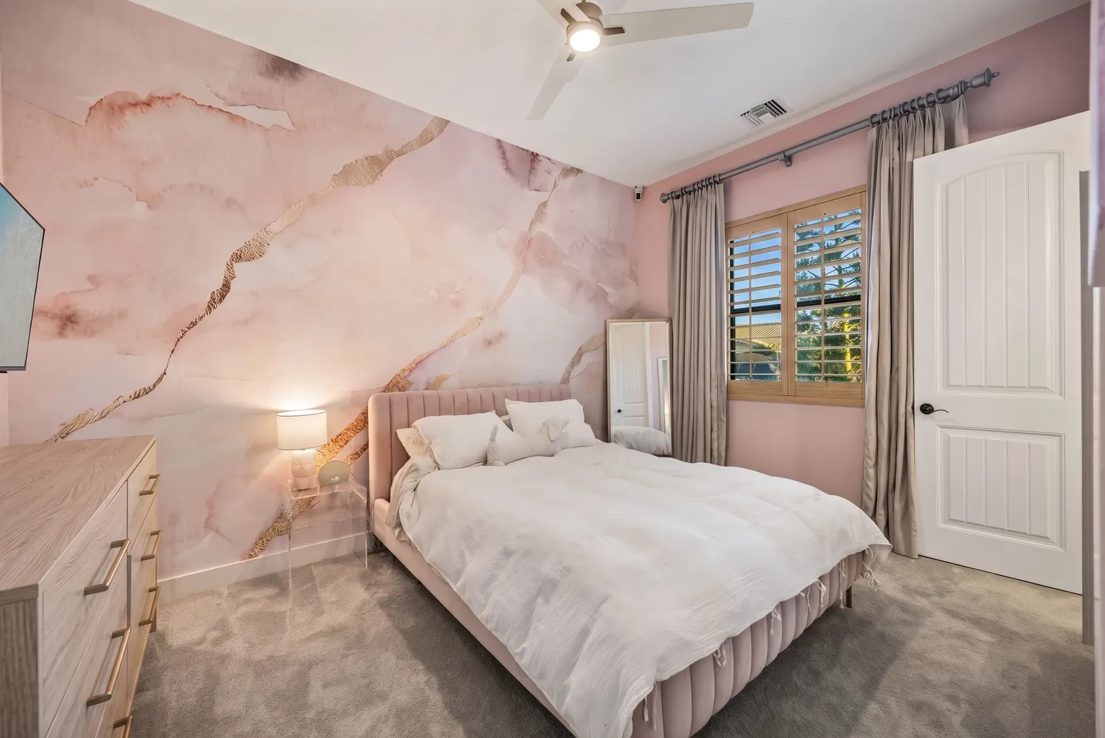 Wood-tone plantation shutters in a Phoenix, Arizona bedroom